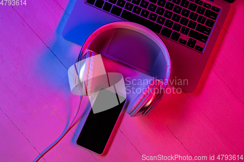 Image of Top view of set of gadgets in purple neon light