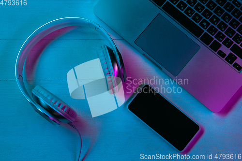 Image of Top view of set of gadgets in purple neon light