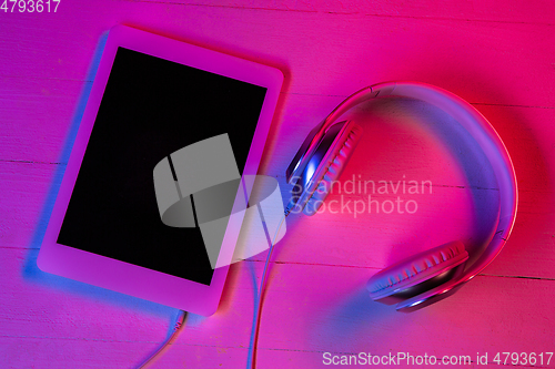 Image of Top view of set of gadgets in purple neon light