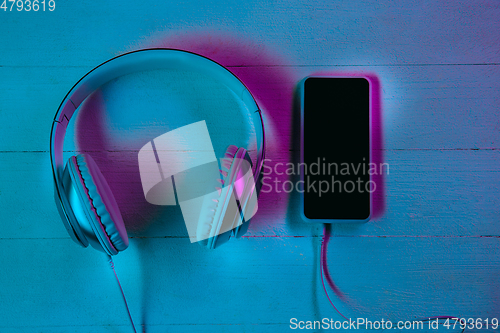 Image of Top view of set of gadgets in purple neon light