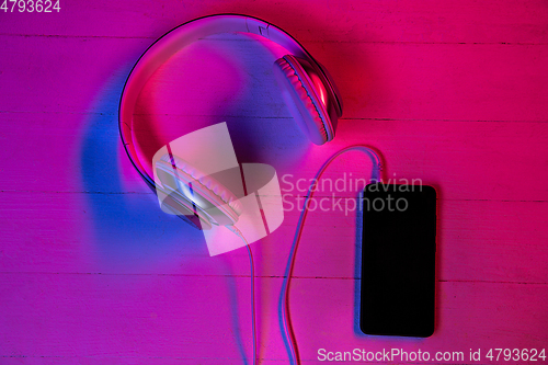 Image of Top view of set of gadgets in purple neon light