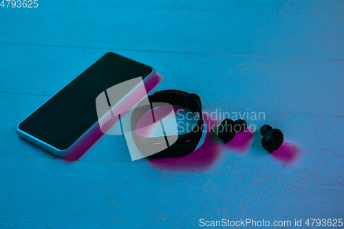 Image of Top view of set of gadgets in purple neon light