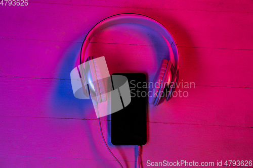 Image of Top view of set of gadgets in purple neon light