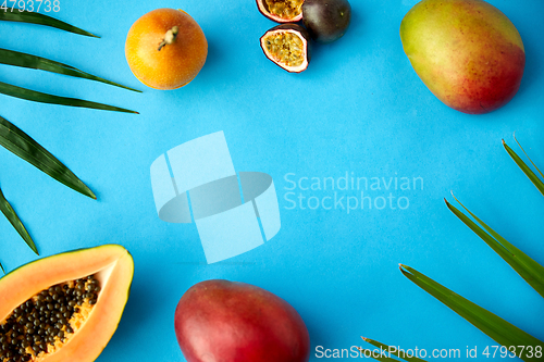 Image of different exotic fruits on blue background