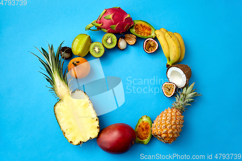 Image of different exotic fruits on blue background