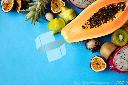 Image of different exotic fruits on blue background