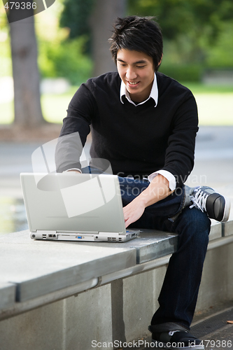 Image of Asian student and laptop