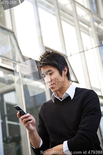 Image of Asian man texting