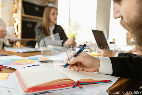 Image of Group of young business professionals having a meeting, creative office