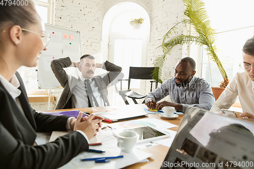 Image of Group of young business professionals having a meeting, creative office