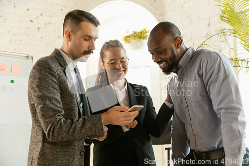 Image of Group of young business professionals having a meeting, creative office