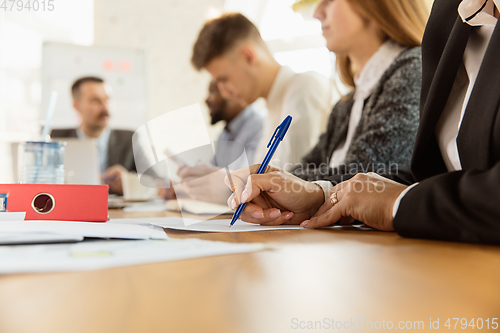 Image of Group of young business professionals having a meeting, creative office