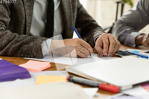 Image of Group of young business professionals having a meeting, creative office