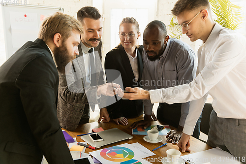 Image of Group of young business professionals having a meeting, creative office