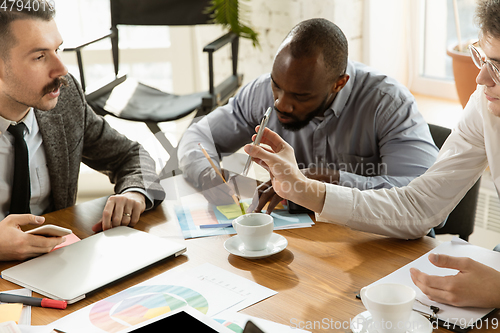 Image of Group of young business professionals having a meeting, creative office