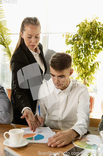 Image of Group of young business professionals having a meeting, creative office