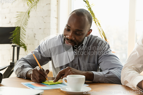 Image of Young business professional preparing for meeting, creative office