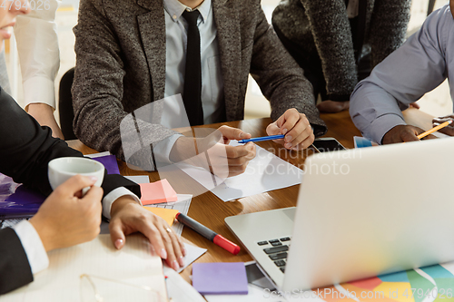 Image of Group of young business professionals having a meeting, creative office