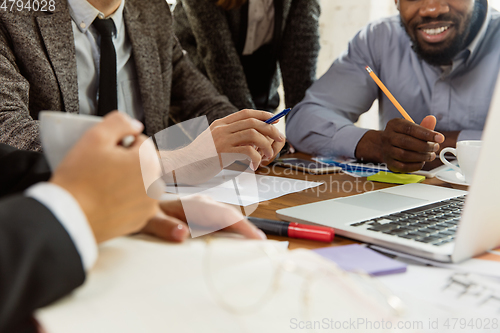 Image of Group of young business professionals having a meeting, creative office