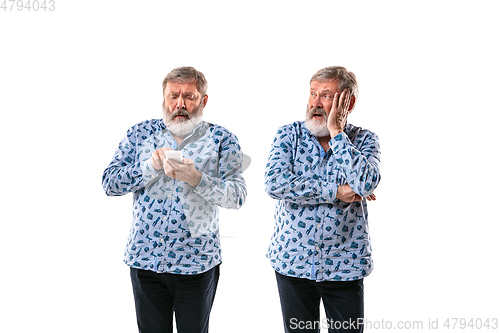 Image of Senior man arguing with himself on white studio background.