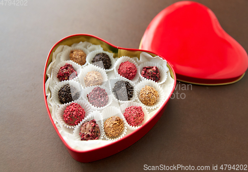 Image of candies in red heart shaped chocolate box