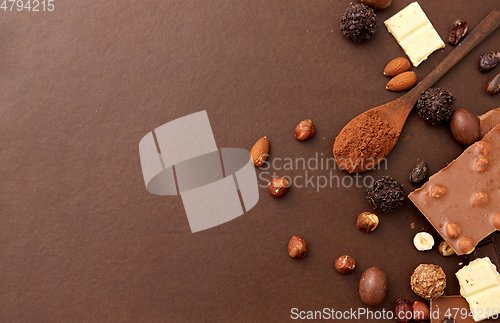 Image of chocolate with nuts, cocoa beans and powder