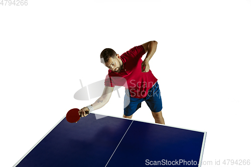 Image of Young man playing table tennis on white studio background