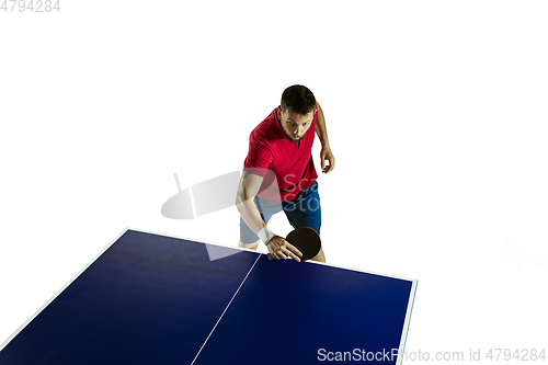 Image of Young man playing table tennis on white studio background