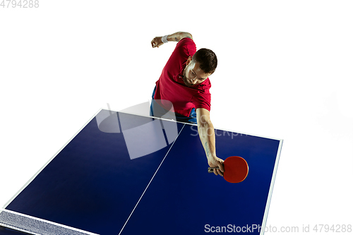 Image of Young man playing table tennis on white studio background