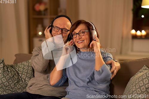 Image of senior couple with headphones listening to music