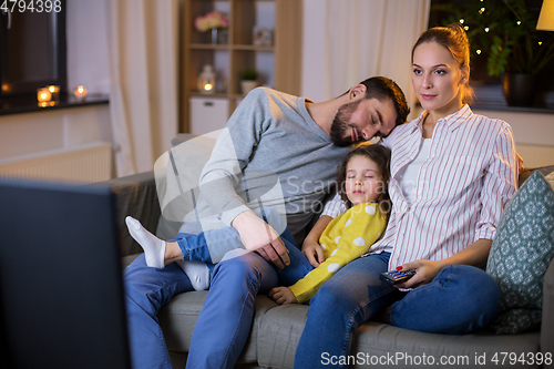 Image of tired sleepy family watching tv at home at night