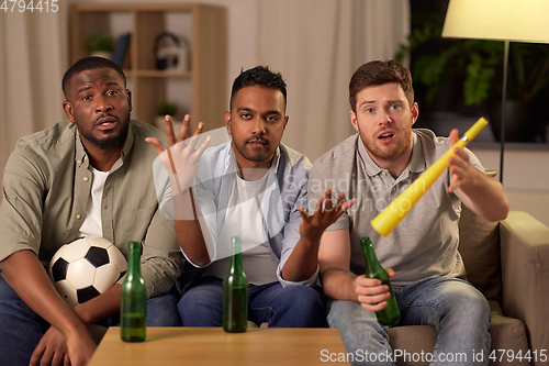 Image of sad male friends or soccer fans with beer at home
