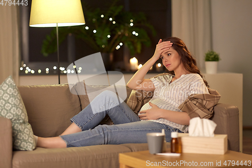 Image of sick pregnant woman having headache at home