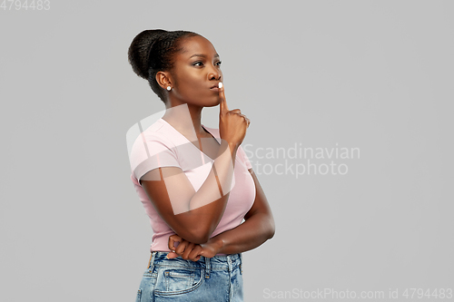 Image of african american woman with finger on lips