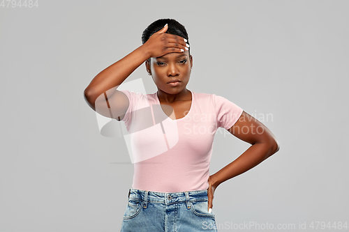 Image of african american woman having headache or fever