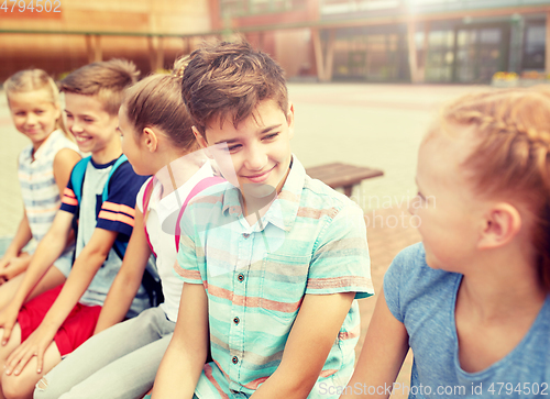 Image of group of happy elementary school students talking