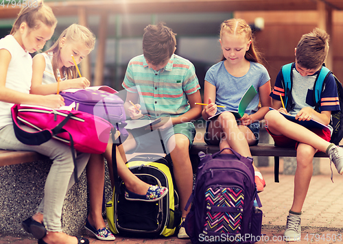 Image of group of happy elementary school students outdoors