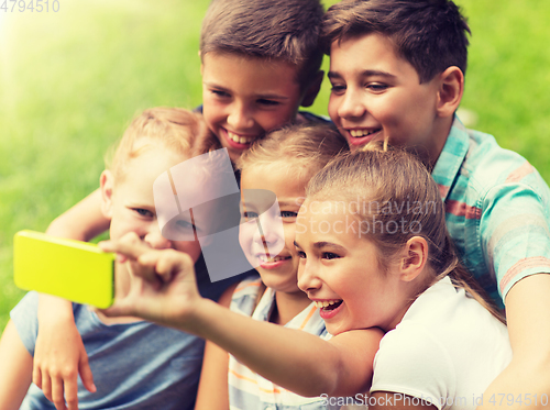 Image of happy kids or friends taking selfie in summer park