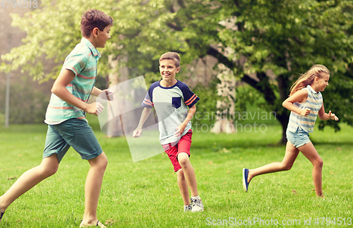 Image of happy kids running and playing game outdoors