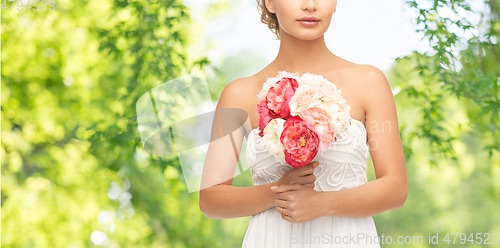 Image of young woman or bride with bouquet of flowers