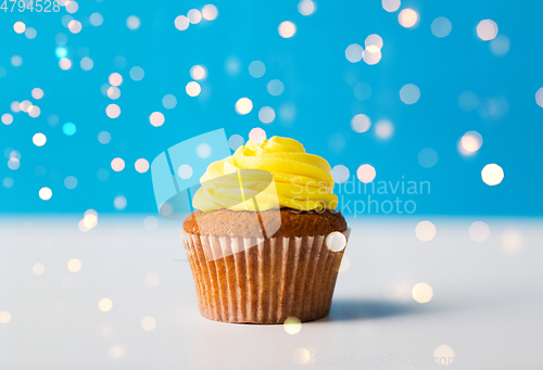 Image of close up of cupcake or muffin with yellow frosting