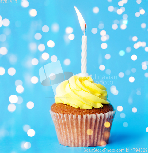 Image of birthday cupcake with one burning candle