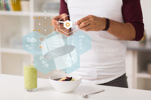 Image of hands with phone and food nutritional value chart