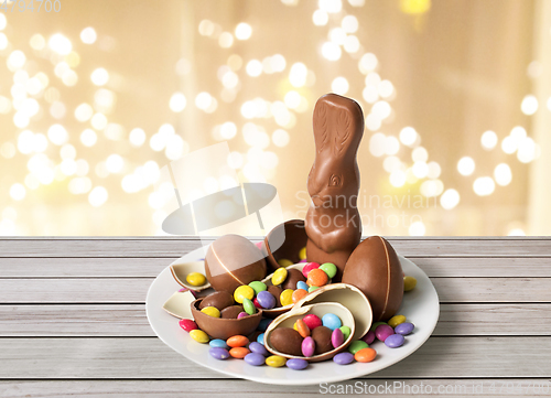 Image of chocolate bunny, eggs and candies over lights