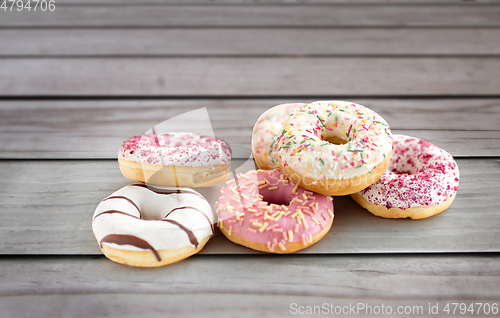 Image of close up of glazed donuts on wooden boards