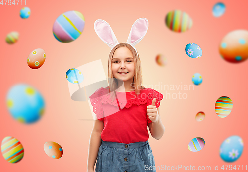 Image of girl wearing easter bunny ears showing thumbs up
