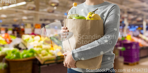 Image of close up of woman with paper bag full of food