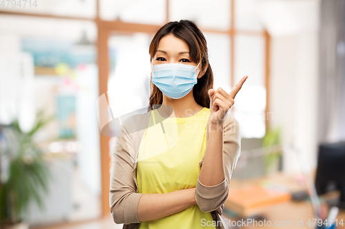 Image of asian young woman in protective medical mask