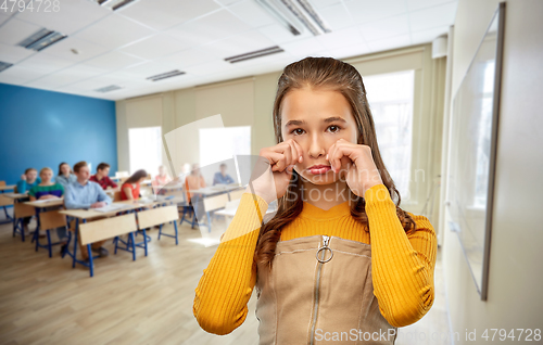 Image of unhappy teenage student girl crying at school