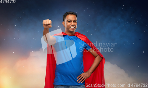 Image of indian man in superhero cape makes winning gesture